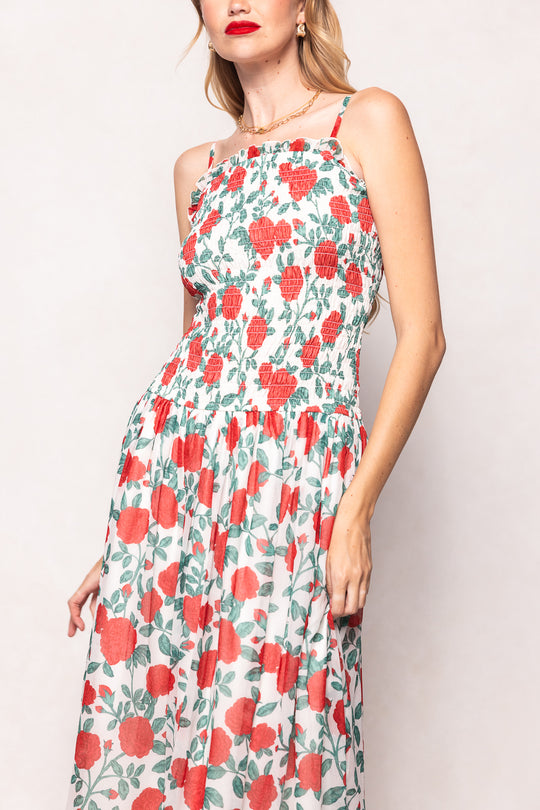 Woman wearing a floral dress with red flowers on a light background