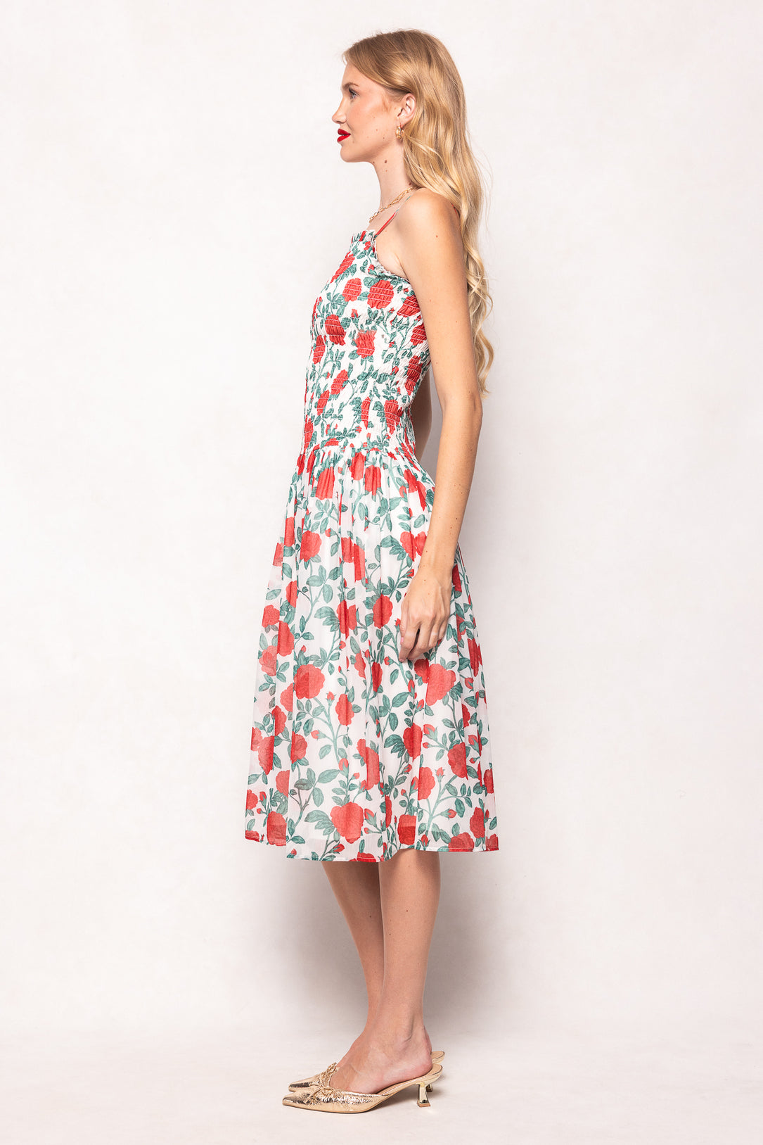 Woman wearing a floral dress against a white background