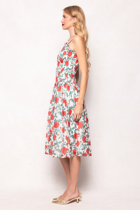 Woman wearing a floral dress against a white background