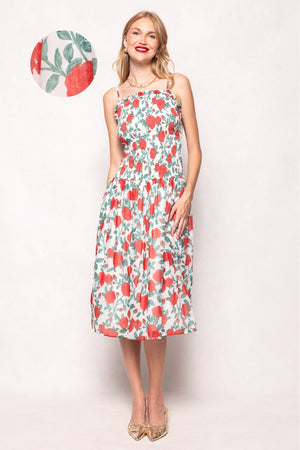 Woman wearing a floral dress with a small inset of the dress pattern.