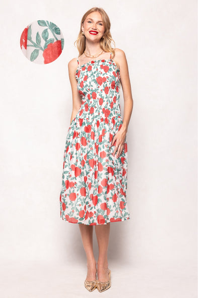 Woman wearing a floral dress with a small inset of the dress pattern.