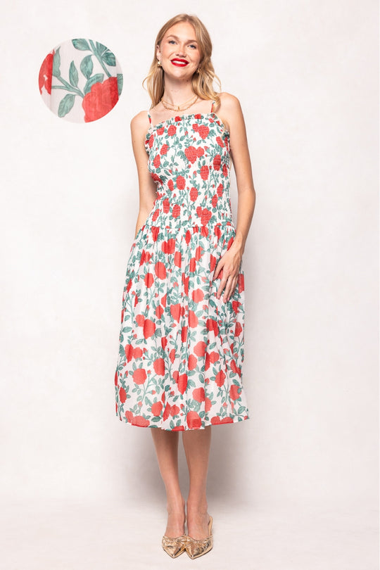 Woman wearing a floral dress with a small inset of the dress pattern.