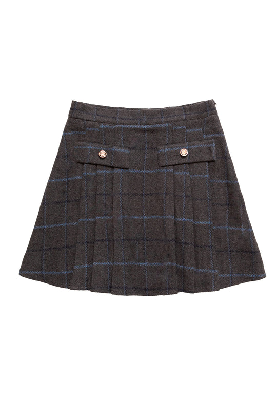 The Kinley Skirt in Charcoal Plaid by Ivy City Co is a pleated, dark gray plaid skirt with blue lines, featuring two decorative buttoned front flap pockets at the waist.