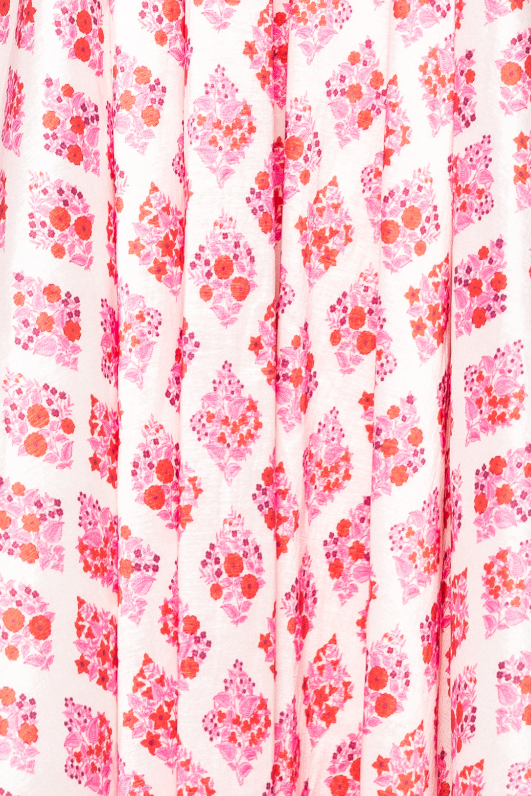 Patterned fabric with pink and red floral design on a white background