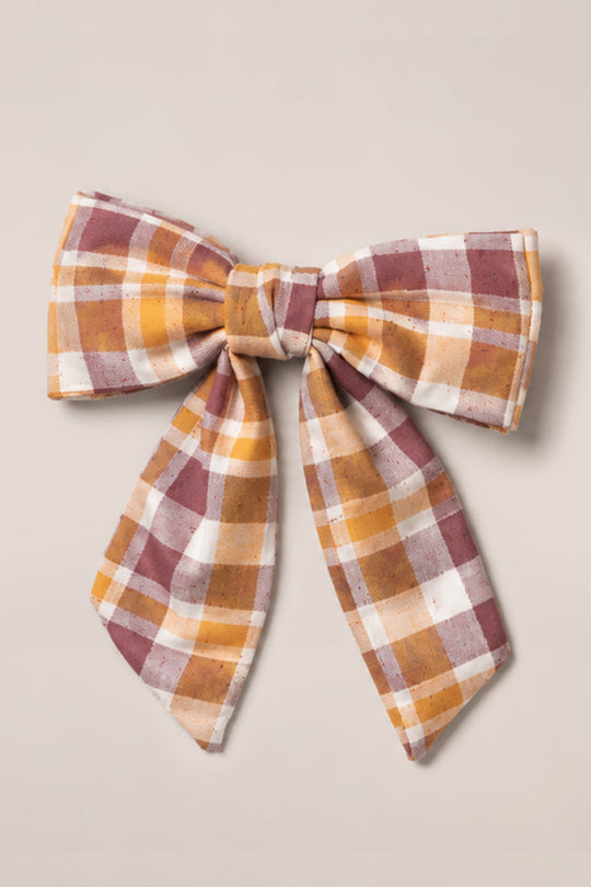 The Ivy City Co Hair Bows in Spiced Plaid feature long cotton tails and a warm pattern of brown, mustard yellow, and white, beautifully displayed against a simple light background.