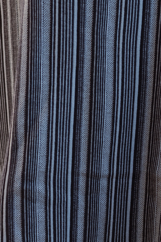 Close-up of the fabric used for the Laurel Dress in Midnight by Ivy City Co, featuring vertical stripes in black, blue, and light gray. The pattern alternates thick and thin lines for a textured, woven look—ideal for this maternity-friendly sweater knit dress.