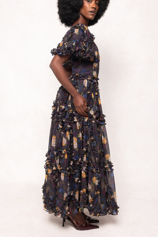 Woman wearing a dark floral dress on a white background