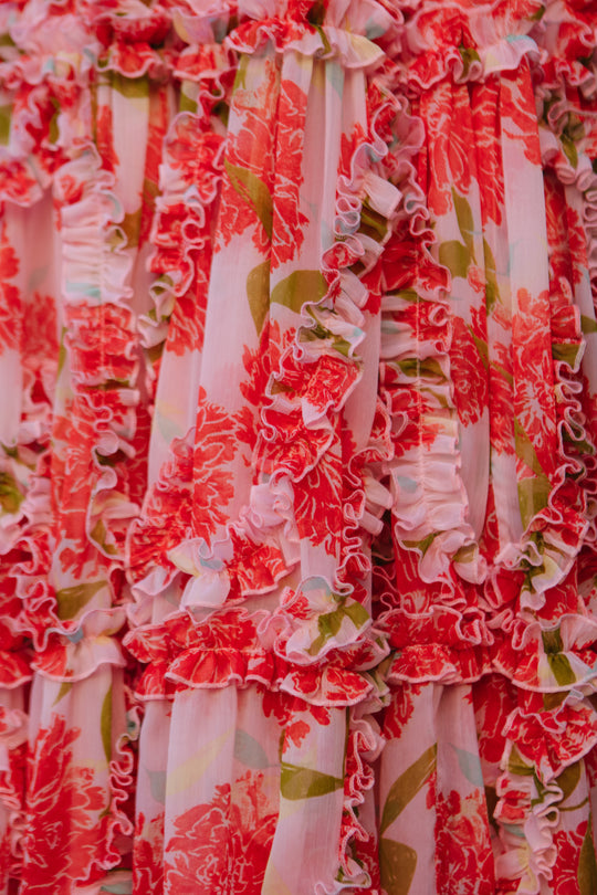 Close-up of the Layla Dress in Pink Floral by Ivy City Co, crafted from lightweight chiffon with green leaves and layered ruffles for a textured, vibrant look—perfect as a chic midi dress.