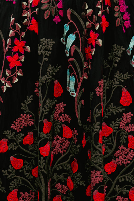 multicolored  dress with embroidery on a black background 