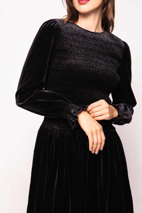 Black dress with long sleeves on a plain background