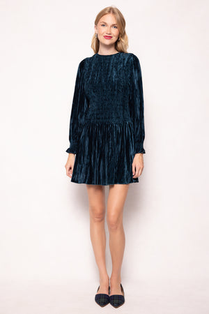 Woman wearing a dark blue velvet dress on a white background