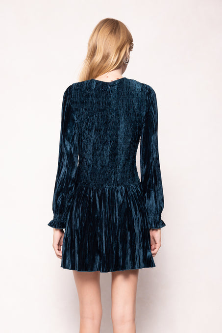 Person wearing a dark blue textured dress on a white background