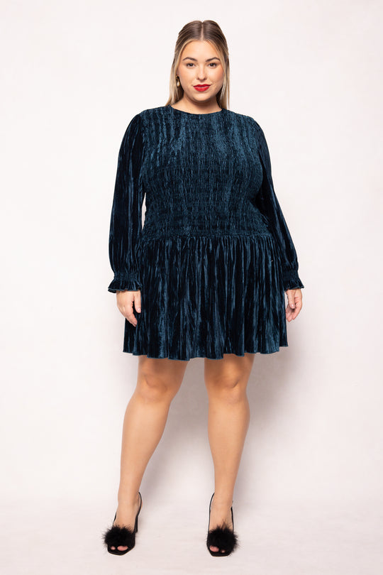 Woman wearing a dark blue dress on a white background