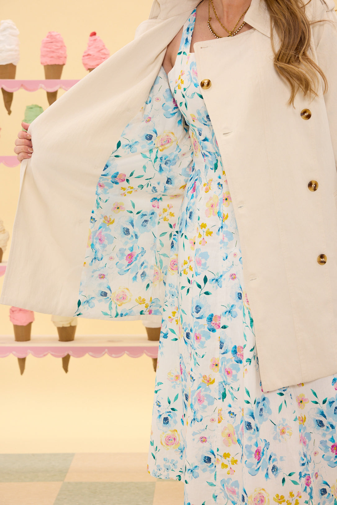 Person wearing a floral dress with a blurred background of ice cream cones.