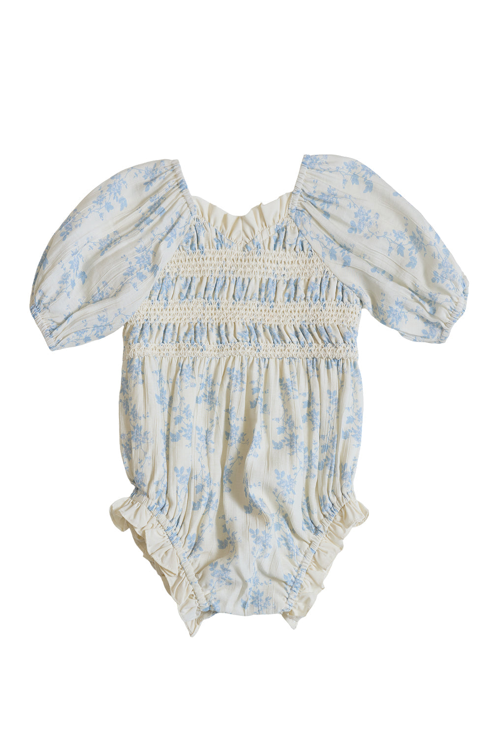 The Baby Roselyn Romper in Ivory Porcelain Fleur by Ivy City Co is a cream-colored romper adorned with a delicate floral print. It features puffed short sleeves, elastic ruffled leg openings, and a smocked bodice accented with ruffle trim at the neckline. The garment is displayed laid flat on a white background.
