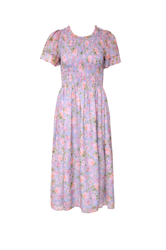 The Ivy City Co Lottie Dress in Vibrant English Garden is a knee-length, short-sleeve floral maternity-friendly dress with a light purple background, smocked bodice, and gathered skirt for comfort and style.