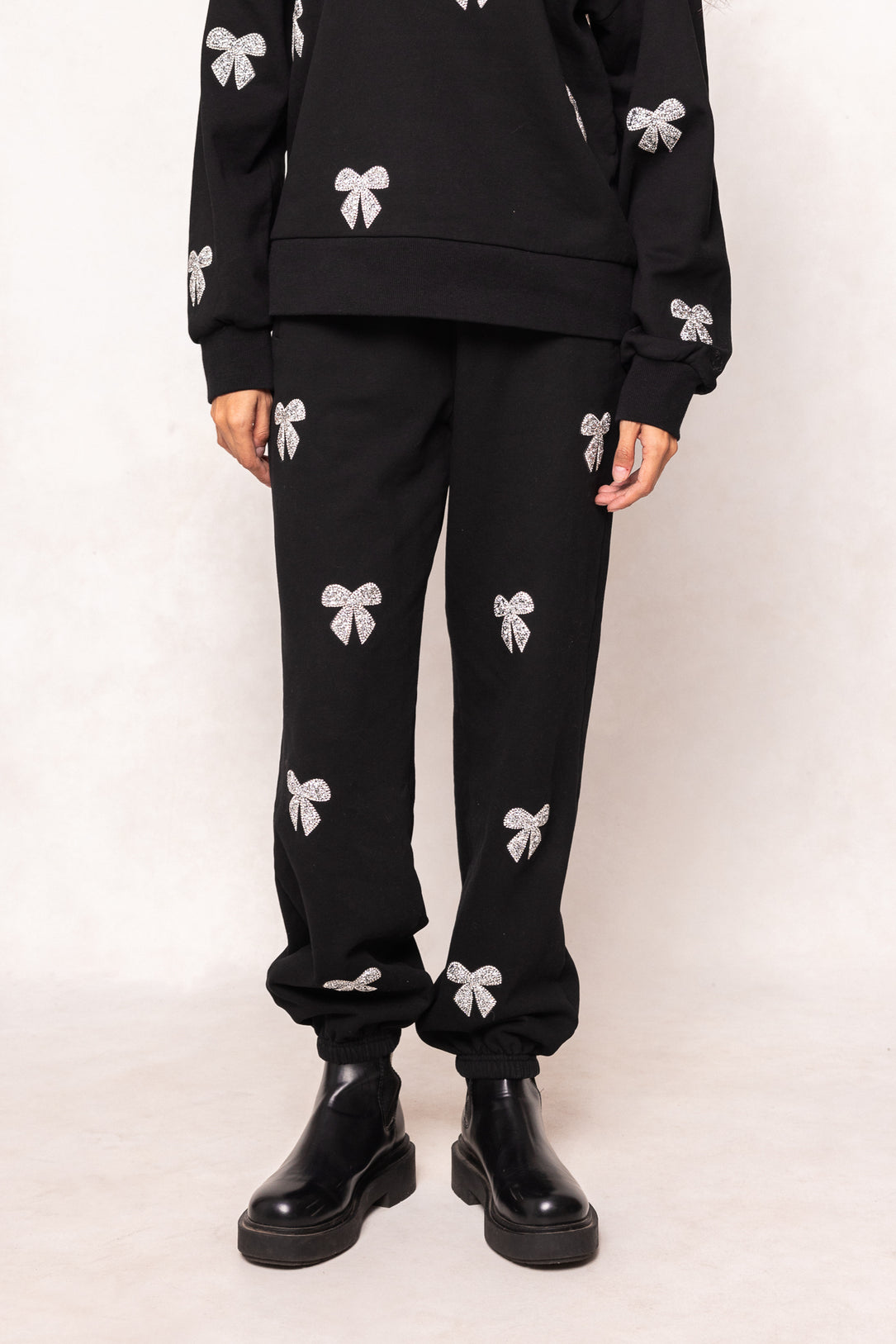 Black outfit with white floral patterns on a white background
