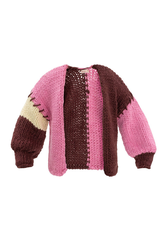 The Marissa Sweater in Pink & Red by Ivy City Co is a chunky knit cardigan featuring wide sleeves, a blend of pink and burgundy hues, and a distinctive beige stripe accent on one sleeve. Designed with both solid and open stitches, this relaxed, cozy piece offers stylish comfort.