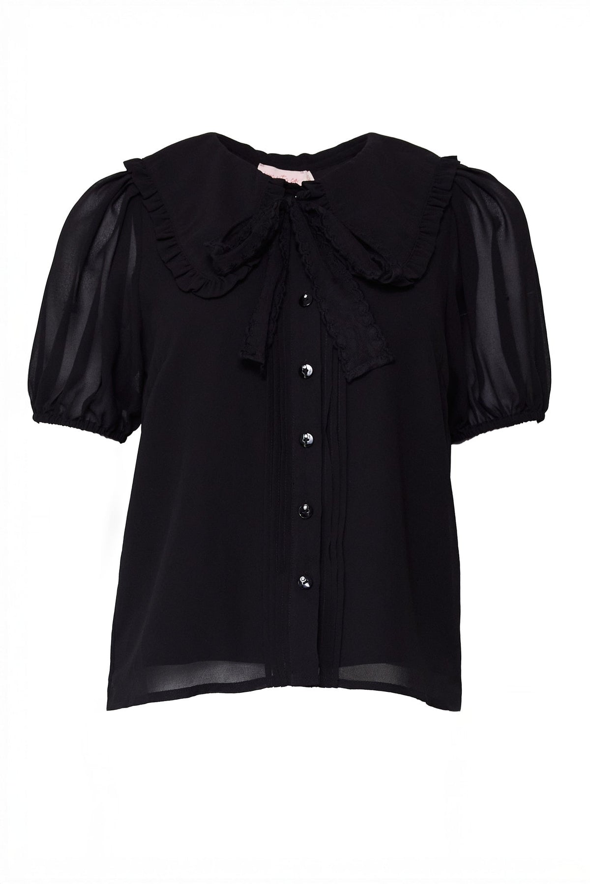 The Andrea Blouse in Black Chiffon by Ivy City Co features short sleeves with sheer puff detailing, a large ruffled collar, front buttons, and a matching bow tied at the neck.