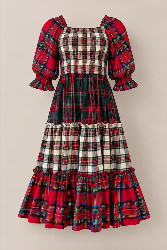 The Madeline Dress in Mixed Plaid by Ivy City Co is a long, tiered dress with puffed sleeves, showcasing festive green, red, and white plaid patterns. Its ruched, fitted bodice pairs with ruffled cuffs and a ruffled hem for a vintage-inspired look that’s both maternity friendly and ideal as a Christmas family dress.