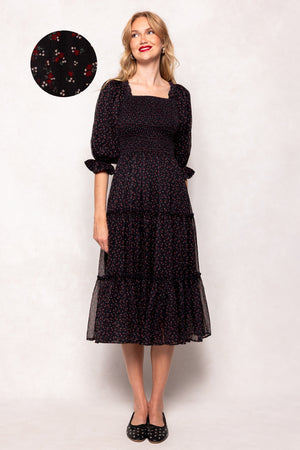 Woman wearing a black dress with a white background