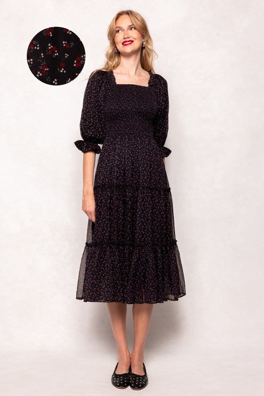 Woman wearing a black dress with a white background