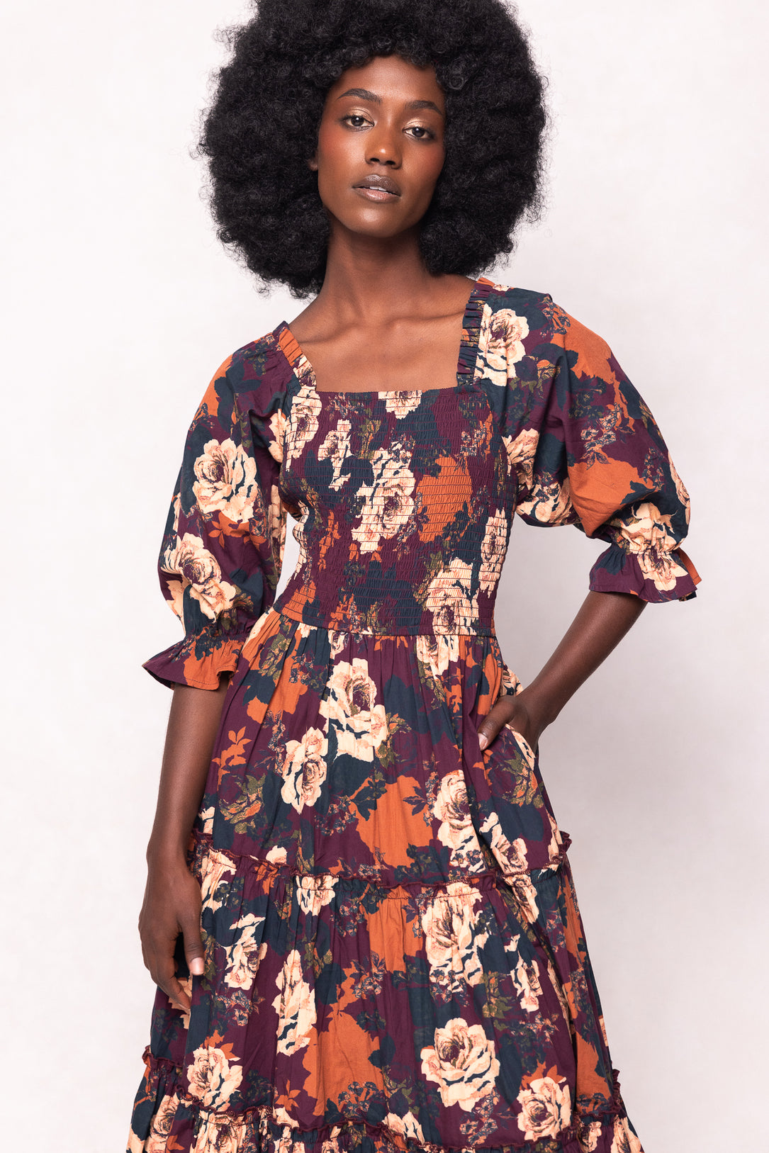 Woman wearing a floral dress with a white background
