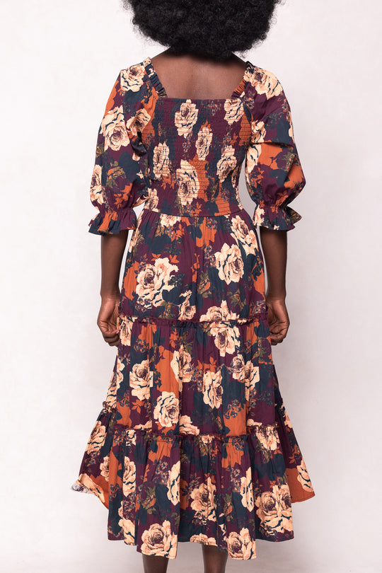 Floral dress with ruffled sleeves worn by a person on a white background