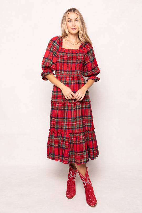 woman in a red plaid dress with red boots on a white background 