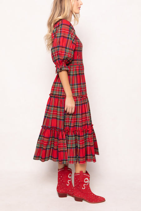 woman in a red plaid dress with red boots on a white background 