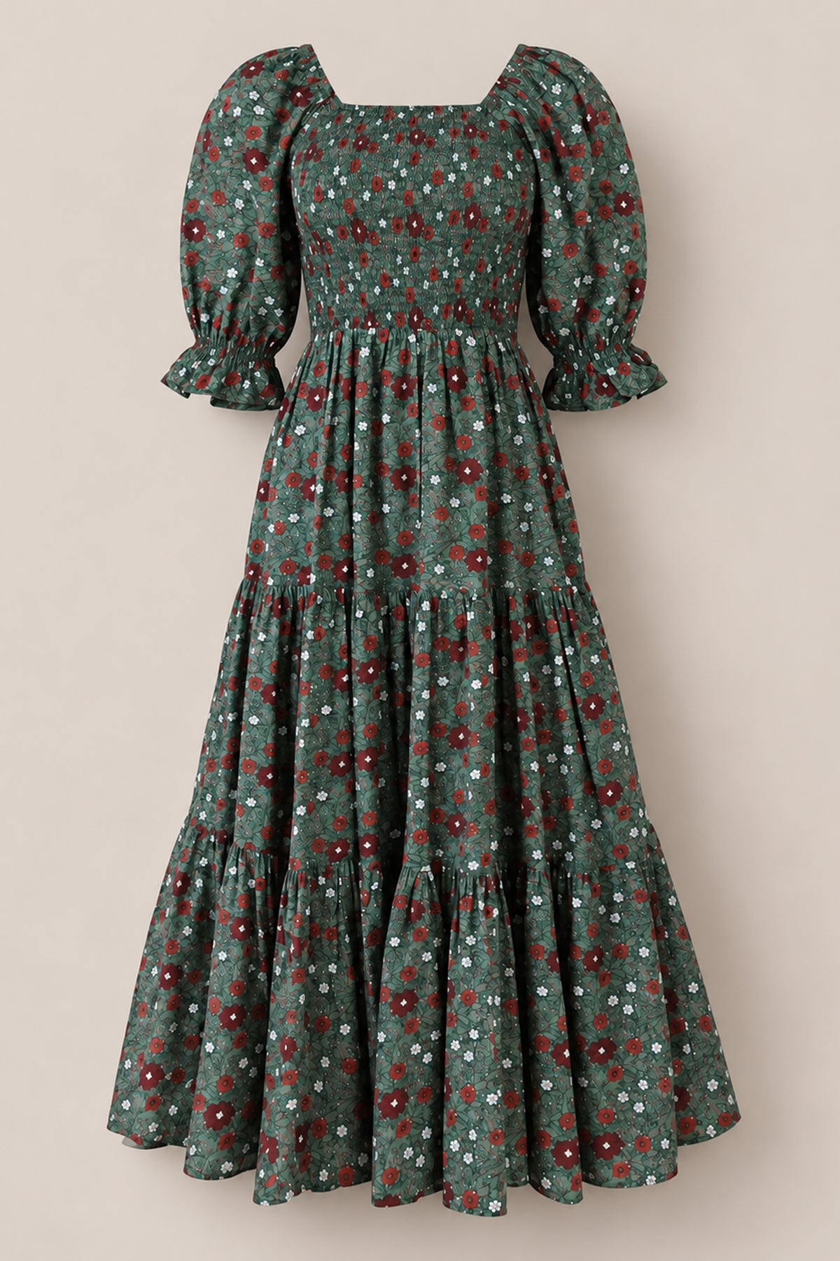 Introducing the Madeline Maxi Dress in Evergreen Merry Ditsy by Ivy City Co—a long, green floral dress featuring a smocked cotton bodice, tiered skirt, and puffed short sleeves. Adorned with small red, white, and blue flowers throughout, this evergreen dress is both maternity and nursing friendly, providing comfort without sacrificing style.