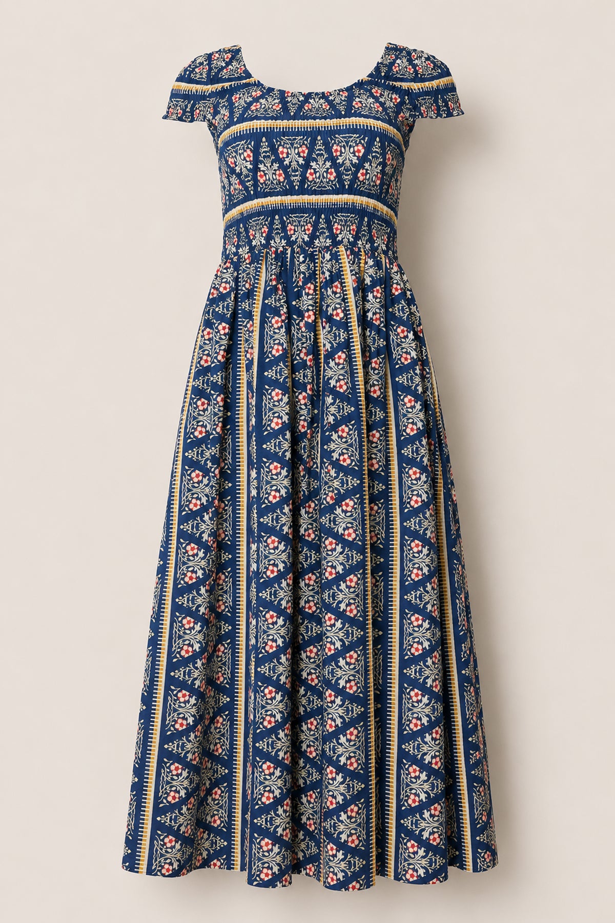 Introducing the Marlow Cap Sleeve Dress in Navy Fleur by Ivy City Co—a blue maxi dress with cap sleeves and a scoop neckline, adorned with a vibrant mix of floral and geometric patterns. The pleated, flowing skirt offers a vintage-inspired bohemian look, while its smocked bodice ensures comfort and flexibility for all-day wear.