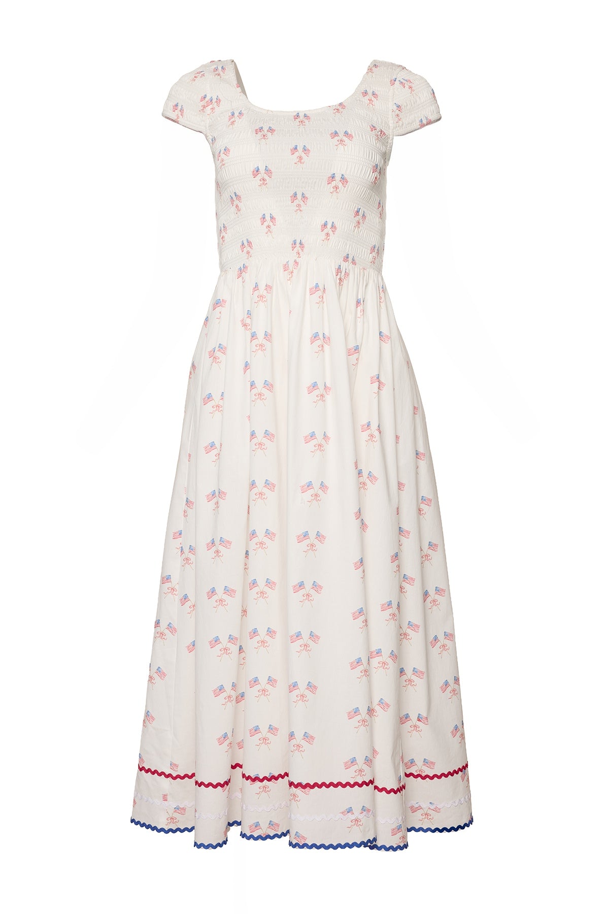 The Marlow Cap Sleeve Dress in Star Spangled by Ivy City Co is a white, ankle-length, maternity-friendly Fourth of July dress with a smocked bodice, cap sleeves, small American flags, and red and blue rickrack trim.
