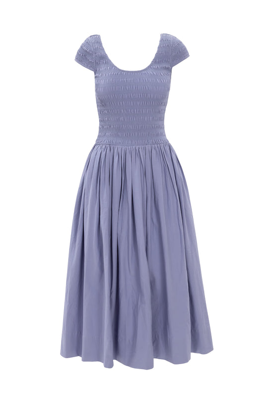 The Marlow Cap Sleeve Dress in Blue by Ivy City Co features a smocked, fitted bodice and pleated midi skirt. Displayed on a white background, its nursing-friendly design offers comfort and convenience for new moms.