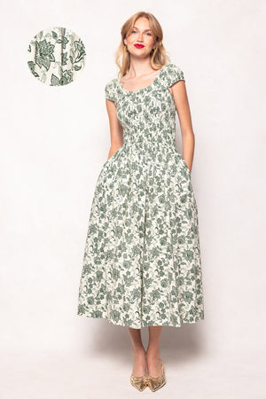 Woman wearing a green floral dress on a white background