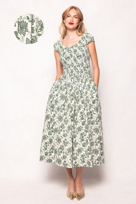 Woman wearing a green floral dress on a white background