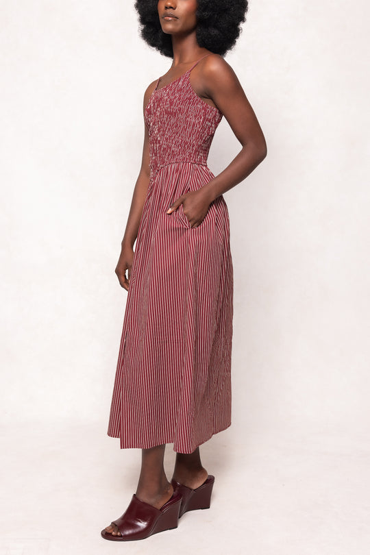 Woman wearing a pink dress with a white background