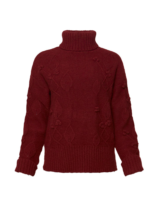 Red sweater with cable knit pattern on a white background