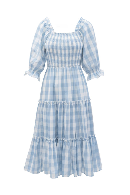 The Mia Gingham Dress in Blue by Ivy City Co features light blue and white gingham, puffed half sleeves, a smocked bodice, tiered mid-length skirt, square neckline, and ruffle details—both stylish and nursing friendly.