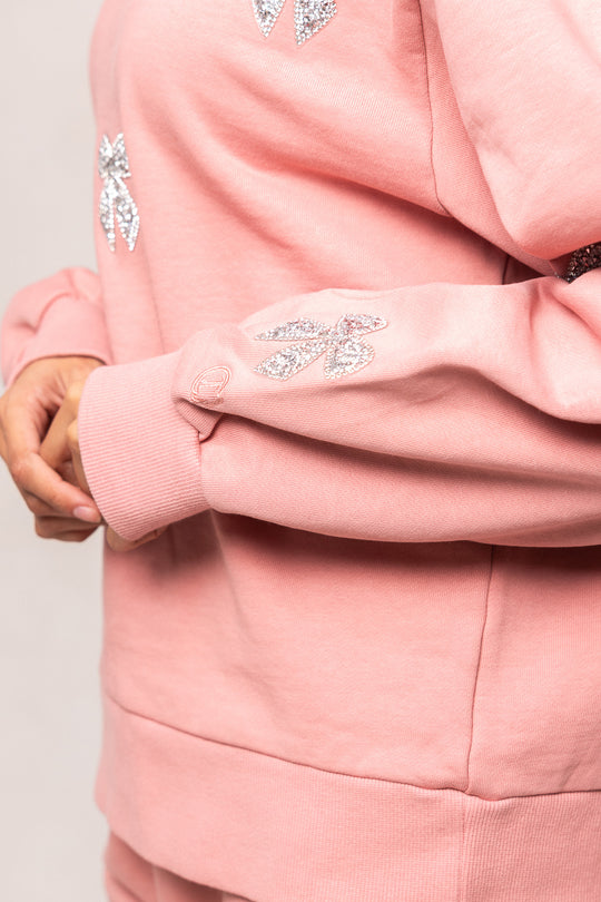 pink sweatshirt against a white background
