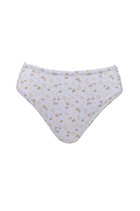 The Ivy City Co Mid Rise Ruched Bottom in Blue Ditsy Floral features a ruched design, blue ditsy floral print, and cheeky coverage, shown against a white background.