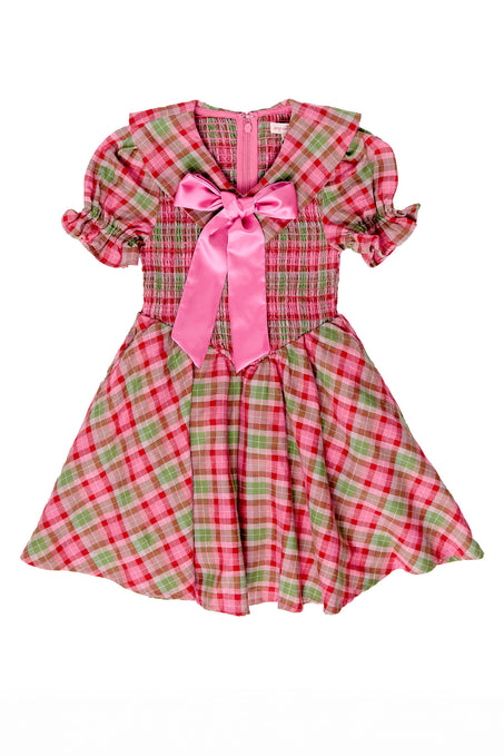 Pink and green plaid dress with a pink bow on a white background