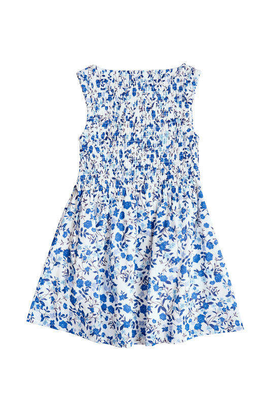 The Mini Ana Dress in Ditsy Cobalt Floral by Ivy City Co is a sleeveless girls' midi dress with a smocked bodice and flared skirt, featuring a white base with blue florals—ideal for matching family looks or mom and me outfits.