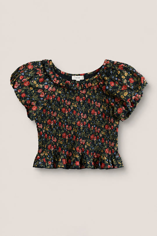The Mini Annalise Top in Obsidian Vintage Poppies by Ivy City Co is a girls’ black short-sleeve smocked crop top featuring a floral print, ruffled hem, and slight puff sleeves, shown on a plain light background.