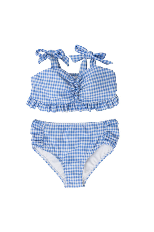The Ivy City Co Mini Brandi Bandeau Top in Blakely Gingham is a blue and white bikini top with ruffled edges and adjustable tie straps, paired with classic-cut bottoms for a charming swimwear set.