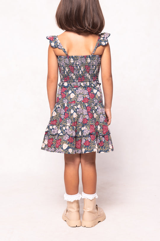 Young girl wearing a floral dress on a white background