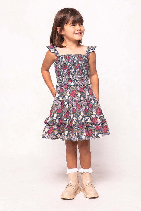 Young girl wearing a floral dress on a white background