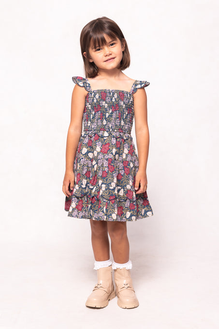 Young girl wearing a floral dress on a white background