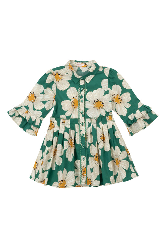 The Mini Bowie Dress in Green with White Floral by Ivy City Co is a stylish girls’ knee-length cotton dress with long sleeves, button-up front, flared skirt, and ruffled cuffs—perfect for any occasion.