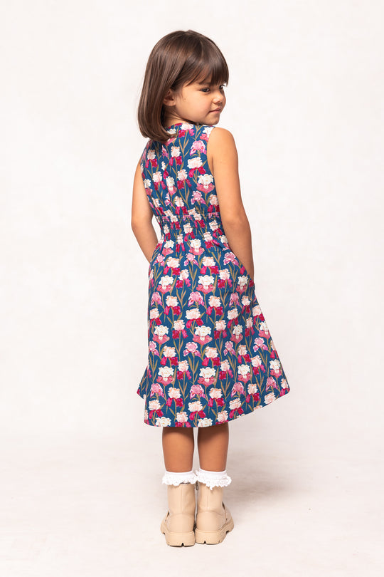 Young girl wearing a floral dress on a white background